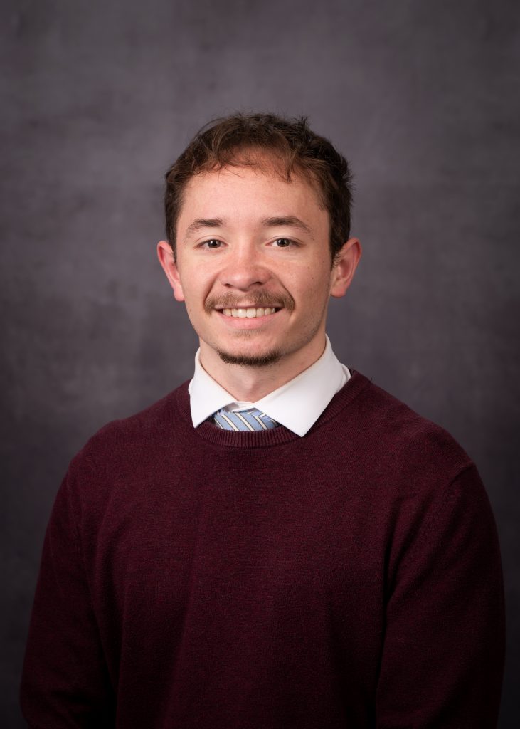 Professional portrait of Jaron Ledesma the Author of Rexburg Money Guide, wearing business attire, smiling and posing confidently.